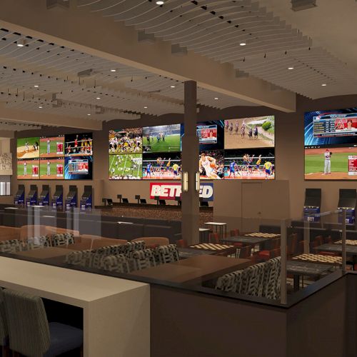 The image shows a sports betting lounge with multiple screens displaying various sports, betting stations, and seating areas.